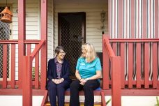 Home Care - Client and support worker sitting on porch